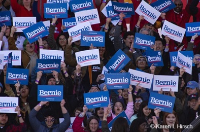 Crown hold up blue and white Bernie signs